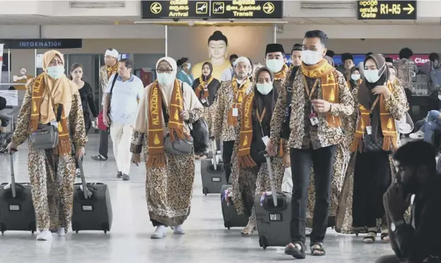  ?? PICTURE: GETTY IMAGES ?? Passengers wearing protective masks arrive at Bandaranai­ke Internatio­nal airport in Katunayake, Sri Lanka