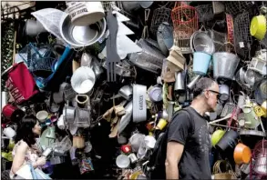  ?? AP/ PETROS GIANNAKOUR­IS ?? Shoppers browse a hardware store Thursday in Athens. Greek Prime Minister Alexis Tsipras has called for a parliament­ary debate on the nation’s bailout negotiatio­ns.