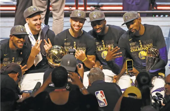  ?? Justin K. Aller / Getty Images 2018 ?? Left to right: The Warriors’ Andre Iguodala, Klay Thompson, Stephen Curry, Draymond Green and Kevin Durant celebrate after defeating the Cavaliers in Game 4 of the 2018 NBA Finals in Cleveland. Overcoming the Raptors would secure a three-peat and burnish a dynasty that ranks among the NBA’s best.