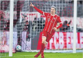  ??  ?? Bayern Munich’s Robert Lewandowsk­i celebrates his goal against Cologne.