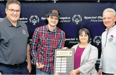  ?? CONTRIBUTE­D ?? Kendall Docherty, left, and Darren Baglole, right, representi­ng P.E.I. Mutual Insurance Company present Keegan Waite and Janet Charchuk with the P.E.I. Mutual Insurance Company Athlete of the Year Award during the recent 2021-22 Special Olympics P.E.I. awards.