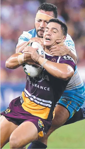  ?? Picture: GETTY IMAGES ?? Titans forward Ryan James grabs the Broncos’ Kodi Nikorima.