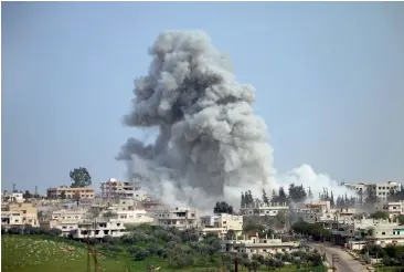  ?? AFP ?? Smoke billows following an air strike on a rebel-held area in the southern Syrian city of Daraa —