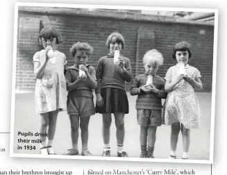  ??  ?? Pupils drink their milk in 1934