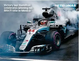  ??  ?? Victory lap: Hamilton celebrates winning his fifth F1 title in Mexico