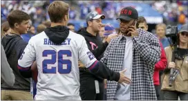  ?? ADAM HUNGER — THE ASSOCIATED PRESS ?? Giants running back Saquon Barkley, right, greets fans on the sidelines before Sunday’s game against the Vikings in East Rutherford.