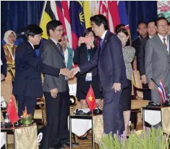  ??  ?? KUALA LUMPUR: Japanese Prime Minister Shinzo Abe (R) greets delegation members during the ASEAN Plus Three (Japan, China and South Korea) Leaders’ Interface with the East Asia Business Council at the 27th (ASEAN) Summit in Kuala Lumpur yesterday. — AFP