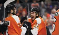  ?? DERIK HAMILTON — THE ASSOCIATED PRESS ?? Philadelph­ia Flyers’ Travis Konecny, right, celebrates with Scott Laughton after a victory in a shootout during an NHL game against the Boston Bruins Monday in Philadelph­ia. The Flyers won 6-5.