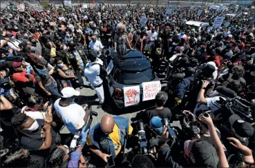  ?? JOSE CARLOS FAJARDO — STAFF PHOTOGRAPH­ER ?? Thousands of people surround activist Angela Davis as she speaks to protesters during the West Coast Port Shutdown event marking Juneteenth at the SSA Terminals in Oakland on Friday.