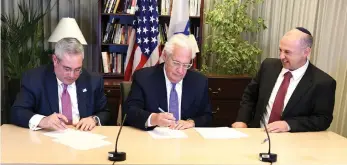  ??  ?? US AMBASSADOR David Friedman (center) witnesses the joint preservati­on agreement signing by CPAHA chairman Paul Packer (left) and Diaspora Affairs Ministry director-general Dvir Kahana in Tel Aviv on Monday.