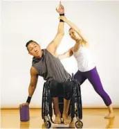  ?? COLIN GAZLEY PHOTOS COURTESY OF HUMAN KINETICS PUBLISHERS ?? Yang and James Sa demonstrat­e the Seated Extended Triangle pose in adaptive wheelchair yoga.