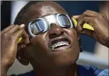  ?? AP 2017 ?? In 2017, 10-year-old Blake Davis of Coral Springs, Florida, watches a total solar eclipse while wearing solar glasses in Davie, Florida.