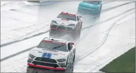  ?? NELL REDMOND — THE ASSOCIATED PRESS ?? From the front, Chase Briscoe, Brandon Jones and Gray Gauilding compete in the rain at Saturday’s Xfinity Series race in Concord, N.C.