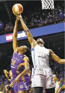  ?? Jim Mone / Associated Press ?? Minnesota’s Sylvia Fowles (right), outreaches Los Angeles’ Nneka Ogwumike for one of her Finals-record 17 rebounds.