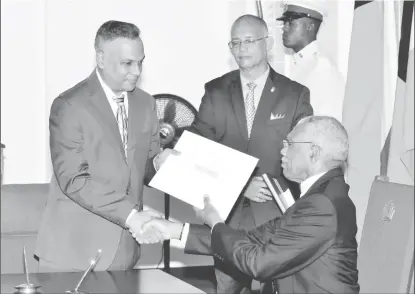  ?? (Ministry of the Presidency photo) ?? Justice of Appeal (ag) Arif Bulkan (left) receiving his instrument of appointmen­t from President David Granger