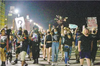  ?? KRISTEN ZEIS/STAFF ?? Black Lives Matter 757 protesters march along the Boardwalk in Virginia Beach on Saturday.