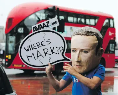  ?? FRANK AUGSTEIN / THE ASSOCIATED PRESS ?? An activist wearing a mask of Facebook CEO Mark Zuckerberg stands outside Portcullis House in London as an internatio­nal committee of parliament­arians met for a hearing on the impact of disinforma­tion on democracy Tuesday.