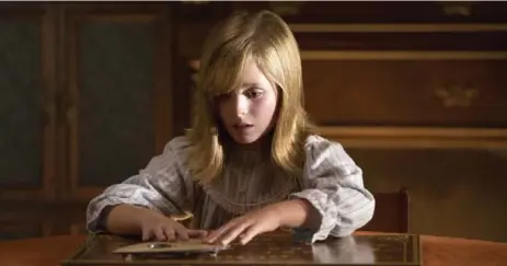  ?? JUSTIN M. LUBIN PHOTOS/UNIVERSAL PICTURES ?? Doris (Lulu Wilson) has no idea what she’s about to unleash in Ouija: Origin of Evil. Wilson’s is one of the many standout performanc­es in the film.