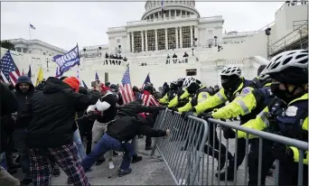  ?? JULIO CORTEZ — THE ASSOCIATED PRESS FILE ?? In this Wednesday, Jan. 6, 2021file photo, Trump supporters try to break through a police barrier at the Capitol in Washington.