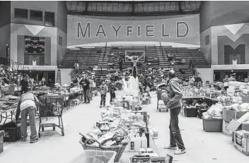  ?? Brandon Bell / Getty Images ?? Mayfield, Ky., was one of several towns that sustained significan­t damage from a historic EF4 tornado. It’s also the hometown of Kentucky linebacker Cody Goatley, a walk-on who’s earned praise from coaches.