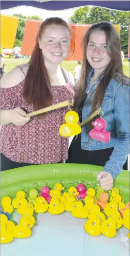  ?? FM4813551 ?? Jaz East and Olivia Copley, both 16, ran the hook a duck stall and couldn’t resist a go