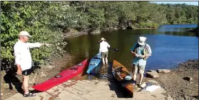  ?? NWA Democrat-Gazette/FLIP PUTTHOFF ?? Gary Lawrence (from left), Susan Lawrence and Warren Cunningham launch Oct. 13 2017 for a circumnavi­gation of Lincoln Lake in their kayaks. The boat ramp is suitable for launching small boats. Only paddlecraf­t or electric motors are allowed on the lake.