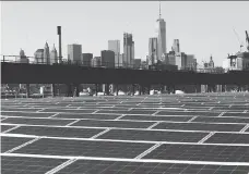  ?? MARK LENNIHAN/AP ?? A rooftop is covered with solar panels in New York. Some analysts believe that plans to boost U.S. solar production are unlikely to create tons of jobs as factories have become increasing­ly automated.