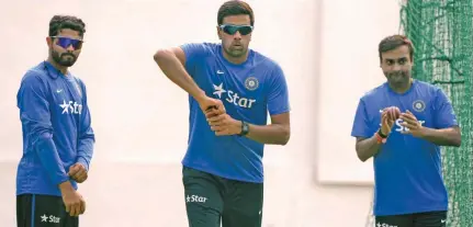  ?? – AFP ?? SPIN TRIO: India’s spin bowlers Ravindra Jadeja, left, Ravichandr­an Ashwin, centre, and Amit Mishra bowl in the nets during a training session on eve of the first Test match against South Africa at The Punjab Cricket Associatio­n (PCA) Stadium in Mohali.