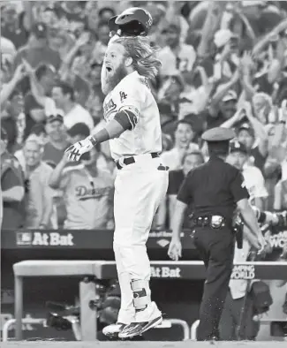  ?? Wally Skalij Los Angeles Times ?? JUSTIN TURNER celebrates his game-winning home run against the Cubs on Sunday. Vin Scully said he would have let the moment speak for itself: “I do my best work saying nothing.”