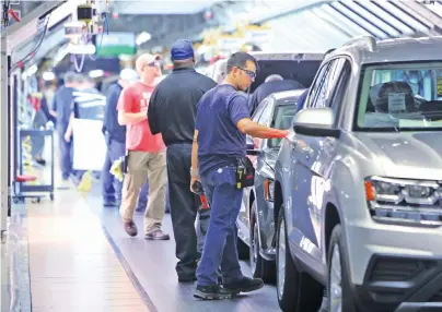  ?? STAFF FILE PHOTO ?? Volkswagen employees perform tests on vehicles as they reach the end of the assembly line at the plant that will build the ID.4 all-electric SUV in 2022.