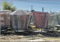  ?? TONY DORIS / THE PALM BEACH POST ?? The once spinning “tops,” carousels known as Los Trompos, sit motionless in a city equipment yard. During the 20 tops’ placement on the waterfront Great Lawn from June to August 2016, 180,000 people used them.