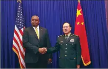  ?? LI XIAOWEI / FOR CHINA DAILY ?? Chinese State Councilor and Defense Minister General Wei Fenghe (right) meets with US Defense Secretary Lloyd Austin in Cambodia on Tuesday morning.