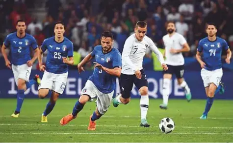  ?? AFP ?? Italy defender Danilo D’Ambrosio tries to beat France forward Antoine Griezmann to the ball during the friendly match at the Allianz Riviera Stadium in Nice, southeaste­rn France, on Friday.