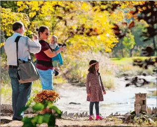  ??  ?? Children and parents explore “Faerievill­e USA.”