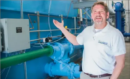  ?? WILLIAM HARVEY/THREE RIVERS EDITION ?? Heath Vaughan of Salado in Independen­ce County, owner of ClearWater Utility Management Services, discusses the new water-treatment plant in Tuckerman. The plant features this Tonka Water filtration system, which processes 800 gallons of water a minute and is fully enclosed in a 4,500-square-foot engineered metal building that was constructe­d on-site. The city owns the water-treatment plant, but it is managed by Vaughan, who can monitor and operate it remotely through his cellphone if he is not on-site.