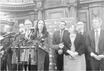  ??  ?? File photo shows Ardern (centre) speaking to the press alongside members of her party after Andrew Little stepped down in Wellington, New Zealand. — Reuters photo