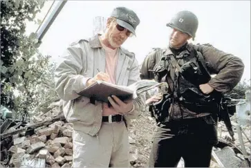  ?? HBO ?? STEVEN SPIELBERG directs Tom Hanks in “Saving Private Ryan,” in s scene from a new documentar­y.