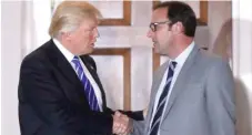  ?? | DREW ANGERER/ GETTY IMAGES ?? President- elect Donald Trump shakes hands with Cubs board member Todd Ricketts after their meeting on Saturday.