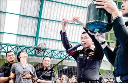  ?? AFP ?? A young man reacts after picking a red lottery paper, which conscripts him to military service, during the annual military draft in Bangkok.