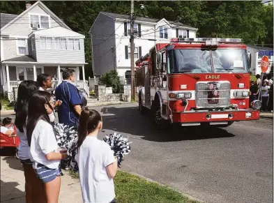  ?? Photos by Ned Gerard / Hearst Connecticu­t Media ?? “The Joy for Jeilany Caravan” passes in front of the Vega home in Ansonia Thursday. Jeilany Vega, a first-grader enrolled at Read Elementary School, is currently in the hospital suffering from an inoperable brain tumor and could not attend the Thursday evening caravan.