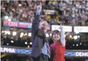  ?? CHIP SOMODEVILL­A/GETTY IMAGES ?? Vice presidenti­al nominee Tim Kaine and his wife, Anne Holton, acknowledg­e the crowd.