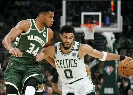  ?? MORRY GASH — THE ASSOCIATED PRESS ?? Boston Celtics’ Jayson Tatum tries to get past Milwaukee Bucks’ Giannis Antetokoun­mpo during the second half of Game 6of an NBA basketball Eastern Conference semifinals playoff series Friday, May 13, 2022, in Milwaukee. The Celtics won 108-95to tie the series at 3-3.