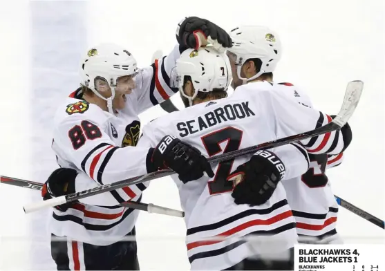  ?? AP ?? Patrick Kane (left) celebrates with Brent Seabrook and Erik Gustafsson after scoring one of his two goals in the third period.