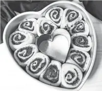  ?? CHULA KING/SPECIAL TO TALLAHASSE­E DEMOCRAT ?? Cut the cinnamon-filled dough into cinnamon rolls and place in a heart-shaped pan to let the yeast work its magic.