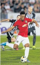  ??  ?? United’s Anthony Martial scores a penalty against Partizan Belgrade.