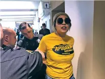  ?? STEVE TERRELL/THE NEW MEXICAN ?? Transgende­r activist Riley del Rey, in a T-shirt showing support for gubernator­ial candidate Jeff Apodaca, is arrested Saturday by Albuquerqu­e police after disrupting the state Democratic Party’s preprimary convention immediatel­y before Apodaca’s rival...