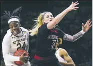  ?? AP/ROBERT FRANKLIN ?? Notre Dame’s Arike Ogunbowale (left) grabs a rebound next to Louisville’s Sam Fuehring during the first half Thursday in South Bend, Ind. Ogunbowale scored 30 points to lead the top-ranked Irish to an 82-68 victory.