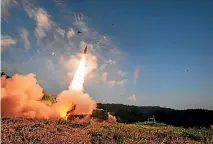  ?? PHOTO: REUTERS ?? South Korean troops fire Hyunmoo Missile into the waters of the Sea of Japan at a military exercise in South Korea yesterday.