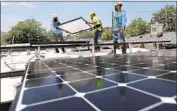  ?? Gary Coronado Los Angeles Times ?? SOLAR PANELS are installed on a low-income home in Watts.