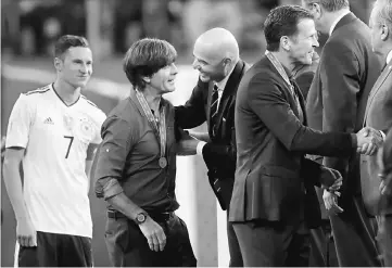  ??  ?? Germany coach Joachim Low (second left) speaks with FIFA President Gianni Infantino after the game. — Reuters photo